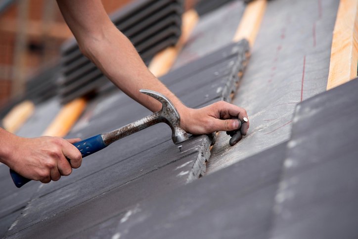 Websites for roofers - a skilled builder working on a roof
