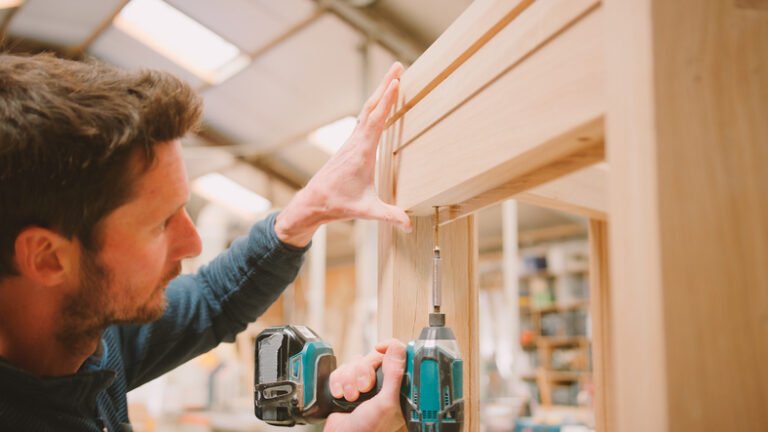 Websites for carpenters - carpenter at work building a cabinet