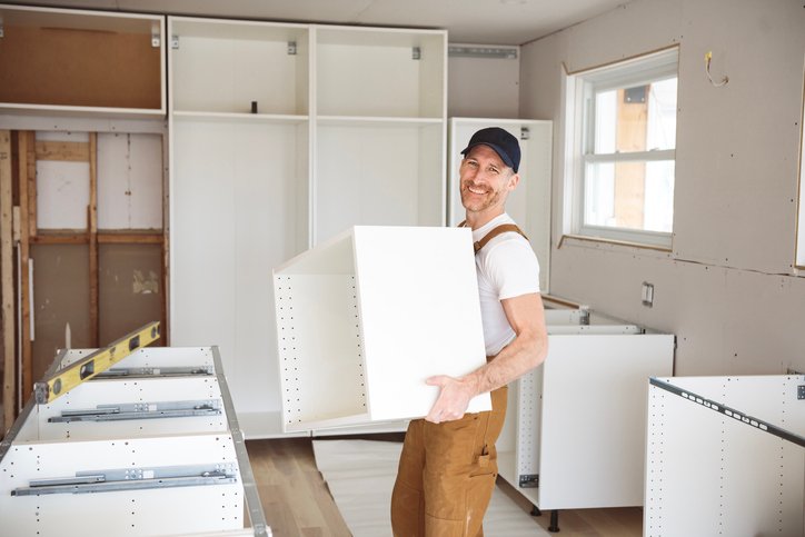 Websites for kitchen installers - carpenter installing a new kitchen in a customers house