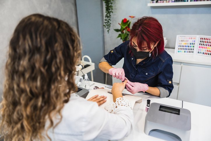 Websites for nail salons - a woman getting a manicure in a local nail salon in dublin