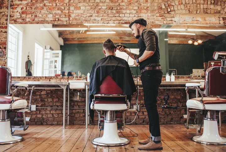 Websites for barbers - a barber working in his shop in Dublin