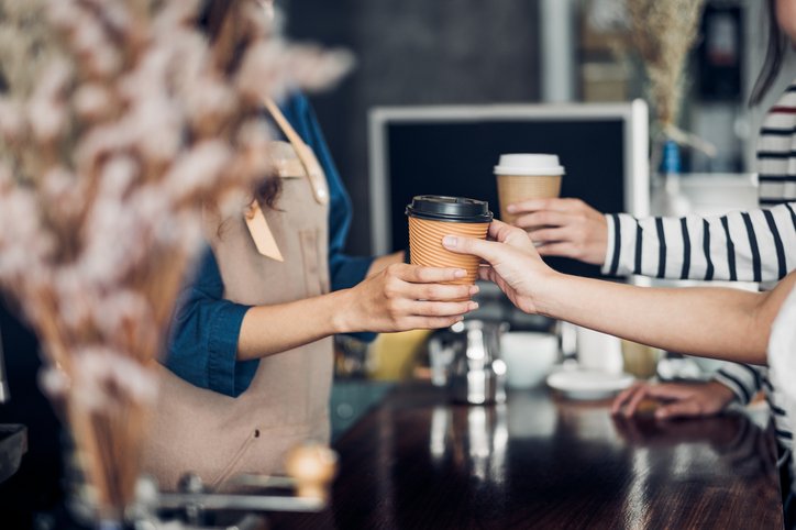 Websites for cafes - a woman in a coffee shop getting her order