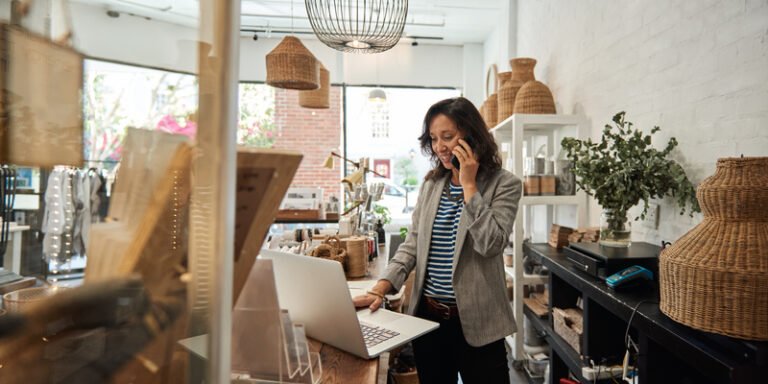 Female at her local business on a phone call